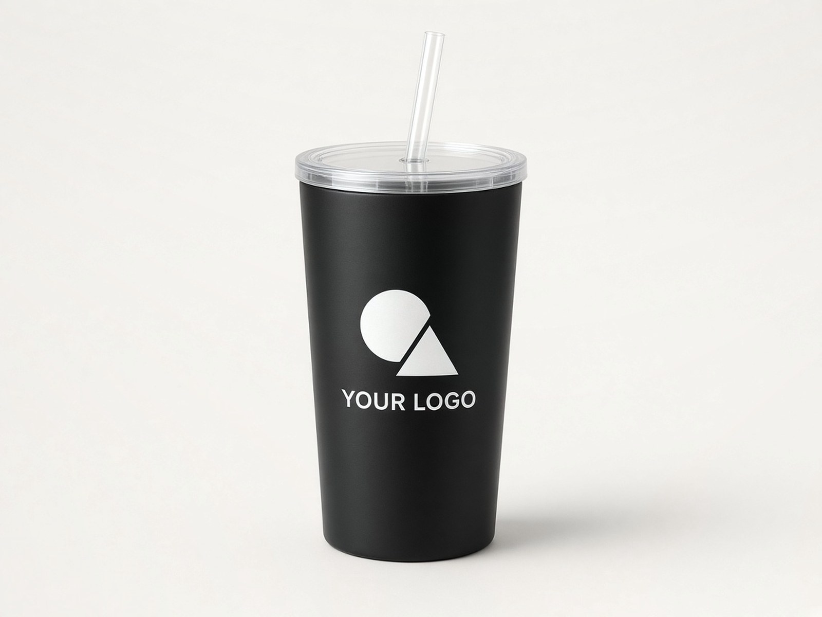 A matte black tumbler with a clear lid and straw, printed in white with an example logo.